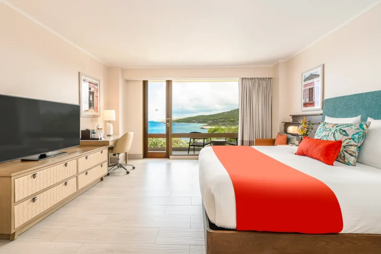 Deluxe Partial Ocean View room with king bed and private balcony at Dreams Curaçao Resort with ocean views.