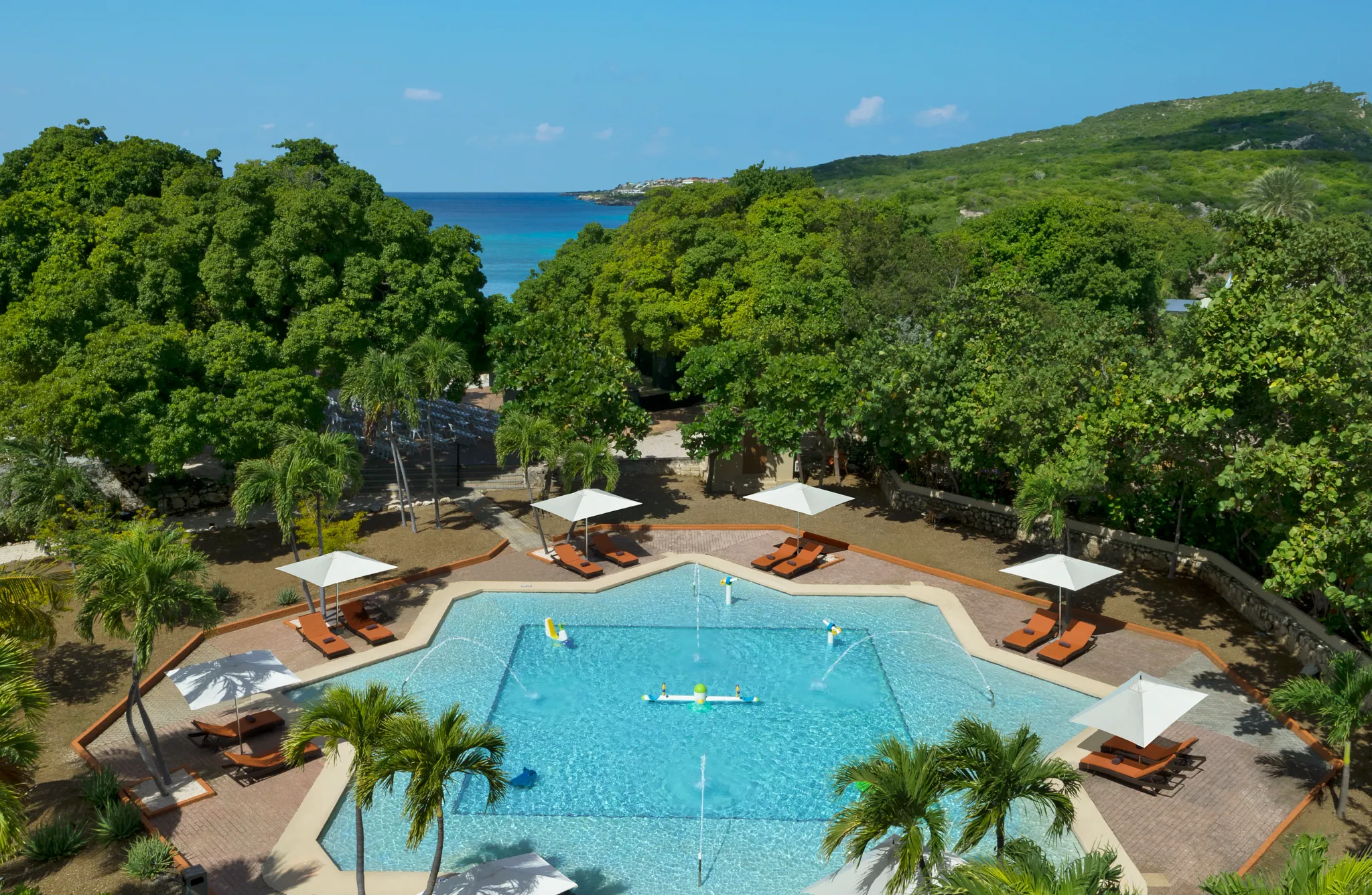Kids pool with water features and lounge chairs at Dreams Curaçao Resort.