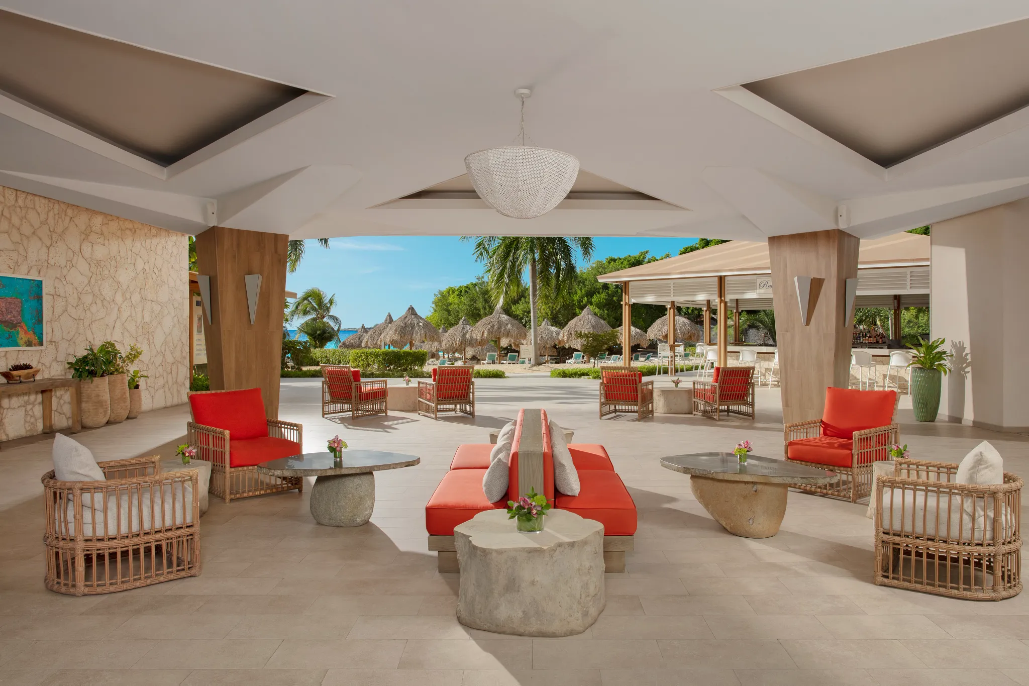 Open-air lobby lounge with modern seating and tropical views at Dreams Curaçao Resort, Spa & Casino.
