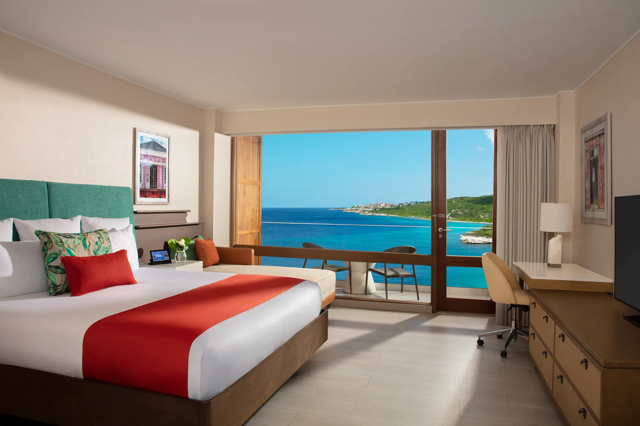 Preferred Club Ocean View room with king bed and private balcony overlooking the Caribbean Sea at Dreams Curaçao Resort.