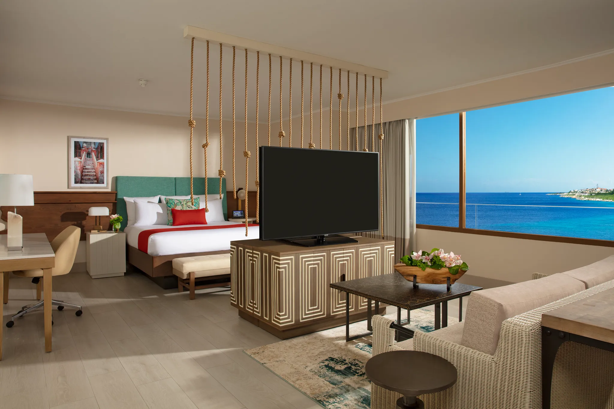 Preferred Club Presidential Suite bedroom with king bed and ocean view at Dreams Curaçao Resort.