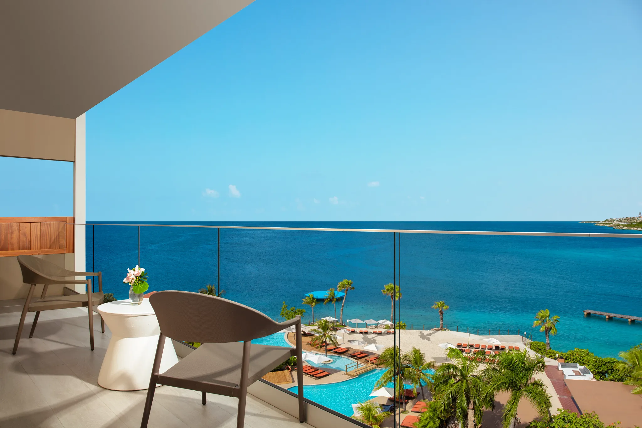 Preferred Club Presidential Suite balcony overlooking pool and Caribbean Sea at Dreams Curaçao Resort.