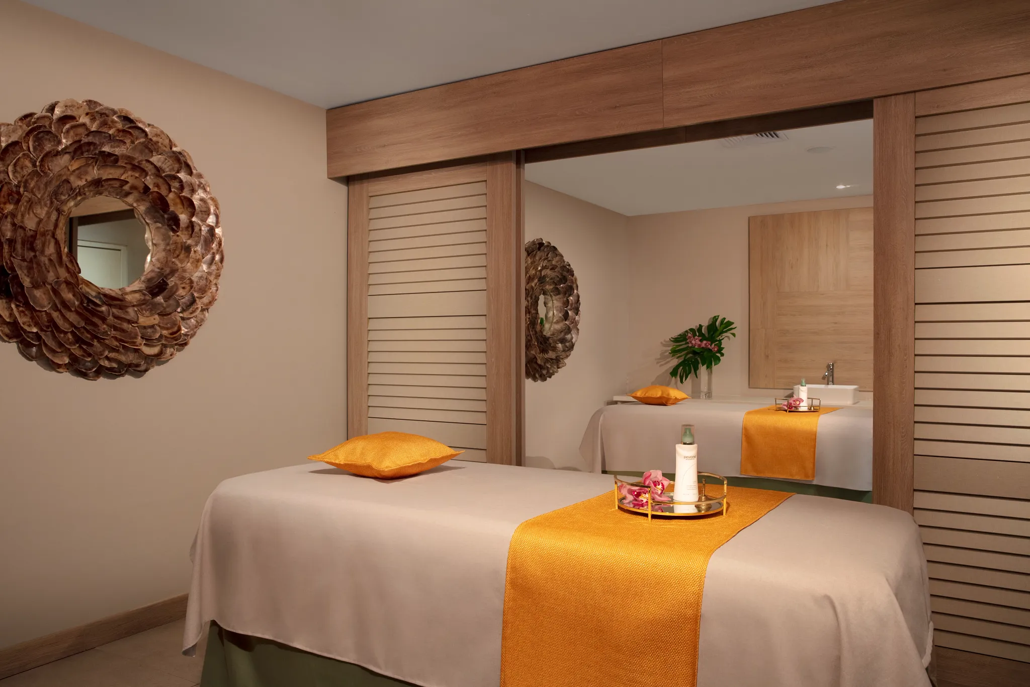 Private spa treatment room with massage table and soothing decor at Dreams Curaçao Resort.
